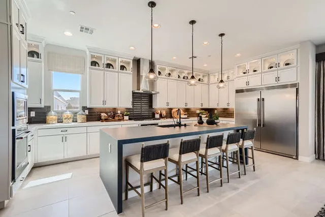 A kitchen with a bar and island.