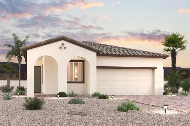 A house with a garage and palm trees.
