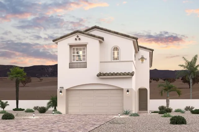 A white building with a garage and palm trees.