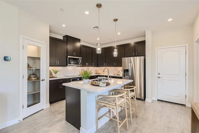 A kitchen with black cabinets.