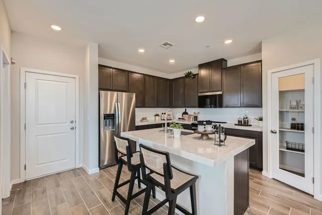 A kitchen with a marble island.