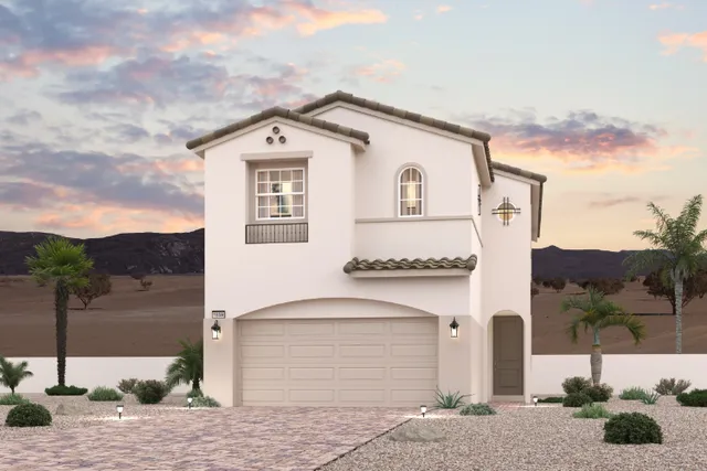 A white building with a garage and palm trees.