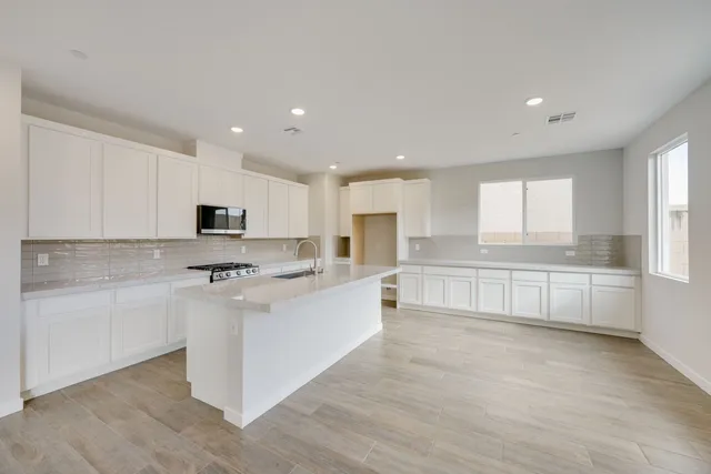 A kitchen with white cabinets.