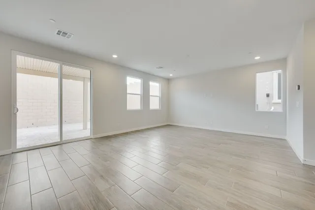 A room with a wood floor and a glass door.