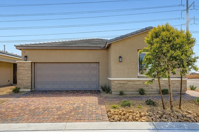 A house with a brick driveway.