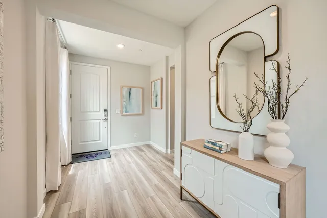A room with a mirror and a table.