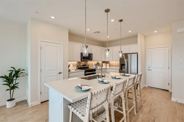 A kitchen with a dining table.