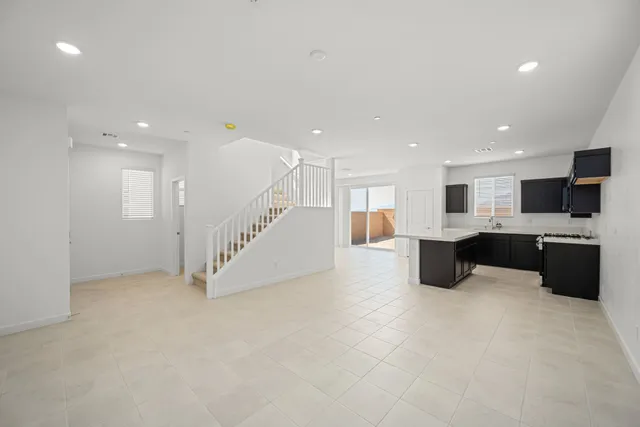 A large white room with a staircase.
