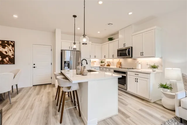 A kitchen with white cabinets.