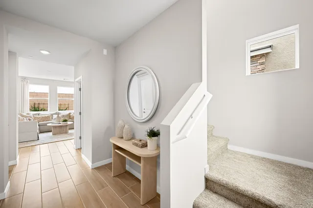 A room with a table and a mirror.