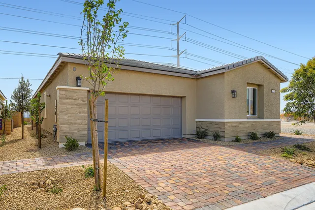 A house with a brick driveway.