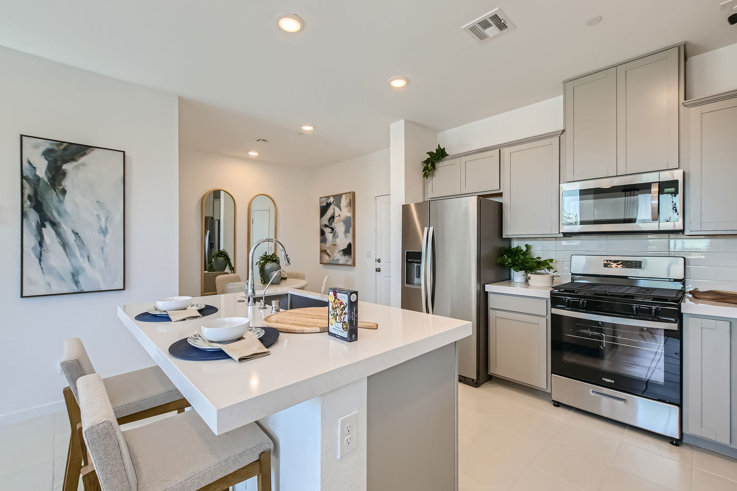 A kitchen with white cabinets.